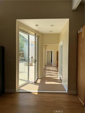a view of a room with window and hardwood floor