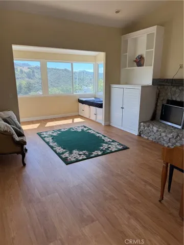 a view of a dry yard with mountains in the background