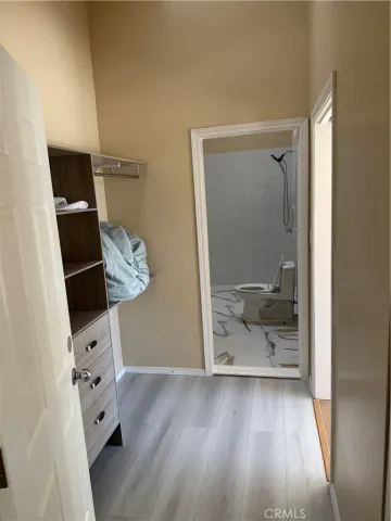 a bathroom with a tub a sink and a large mirror