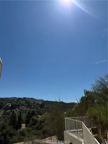 a view of a hallway with bathroom and mirror
