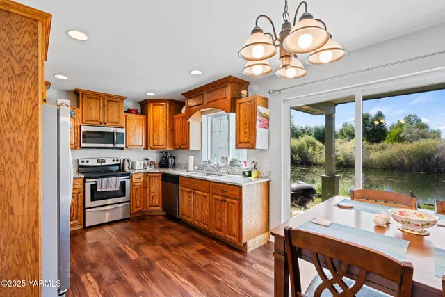 a kitchen with stainless steel appliances granite countertop a stove oven and a refrigerator