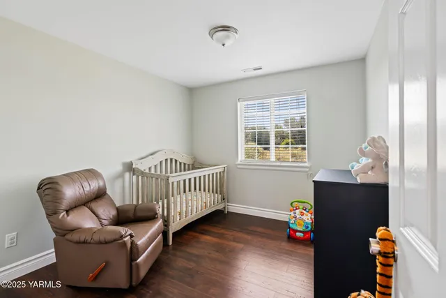 a bedroom with furniture and wooden floor