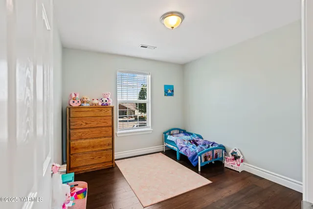 a room with toys and dresser