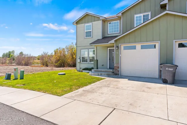 a backyard of a house with fountain and barbeque oven