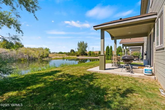 a view of a house with a yard from a patio