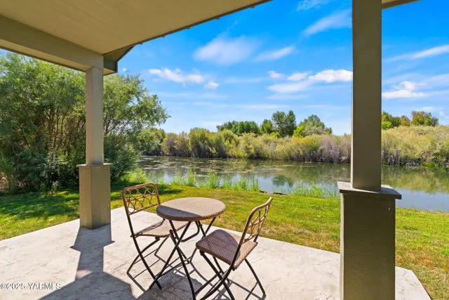 a view of a lake from a balcony with wooden floor