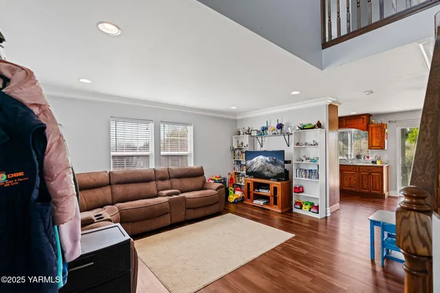 a living room with furniture a wooden floor and a window