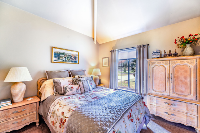 7343 North Sawtooth Cv Road Vernal, UT 84078 - Photo 22 of 64 Vaulted ceiling bedroom with a large window, land carpet flooring