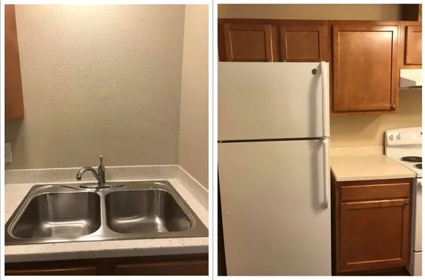 a view of a sink and a refrigerator