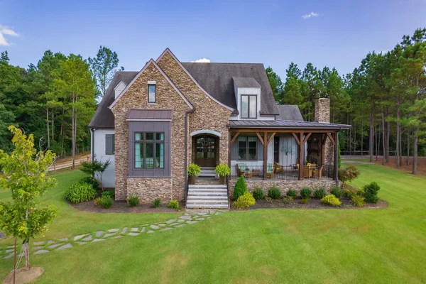 a front view of a house with garden