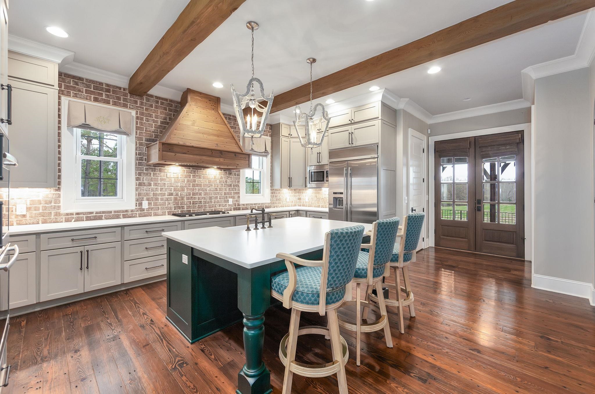 348 Countryside Drive Lexington, TN 38351 - Photo 13 of 39 a large kitchen with a table and chairs in it