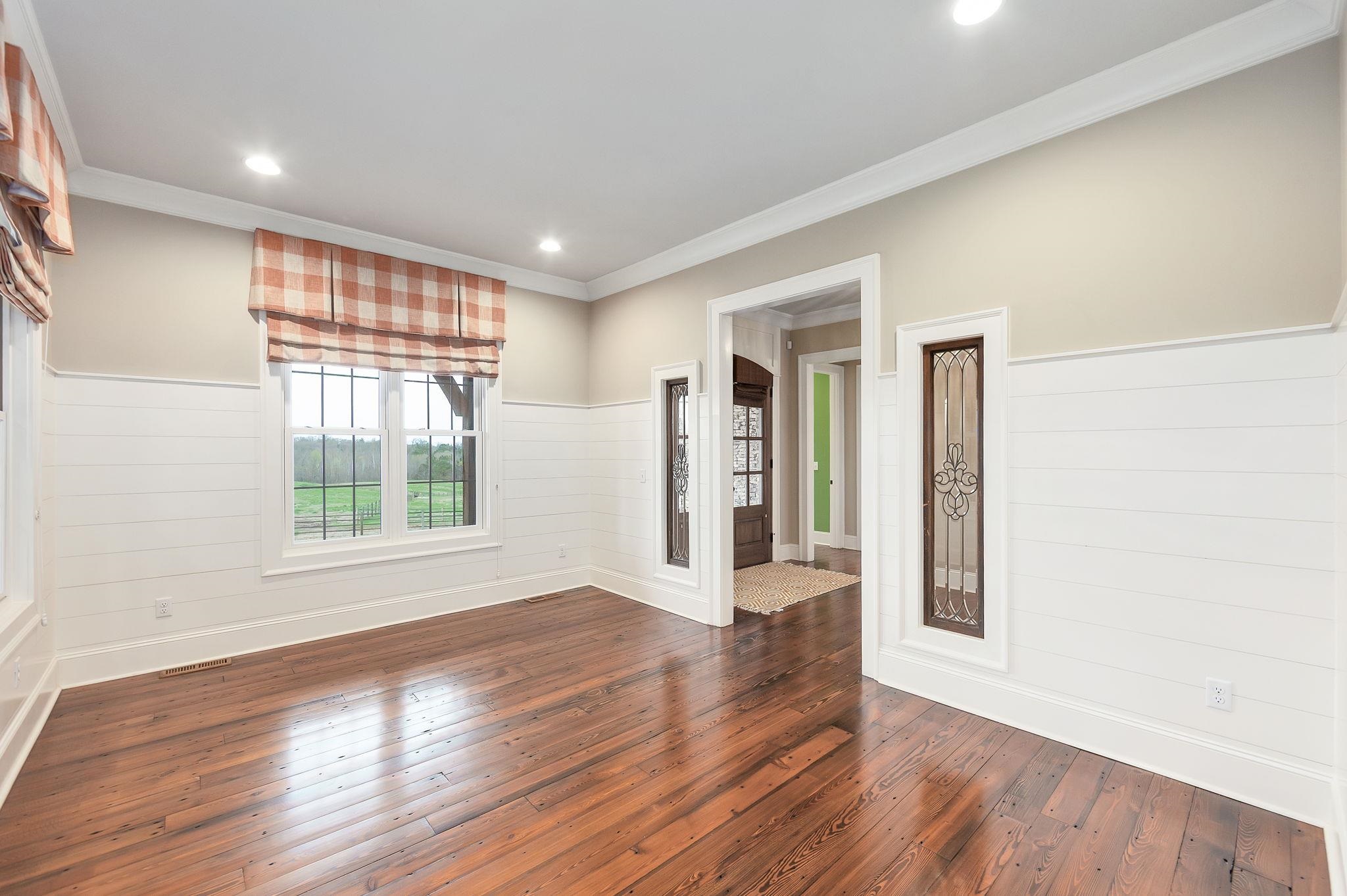 348 Countryside Drive Lexington, TN 38351 - Photo 14 of 39 a view of an empty room with wooden floor and a window