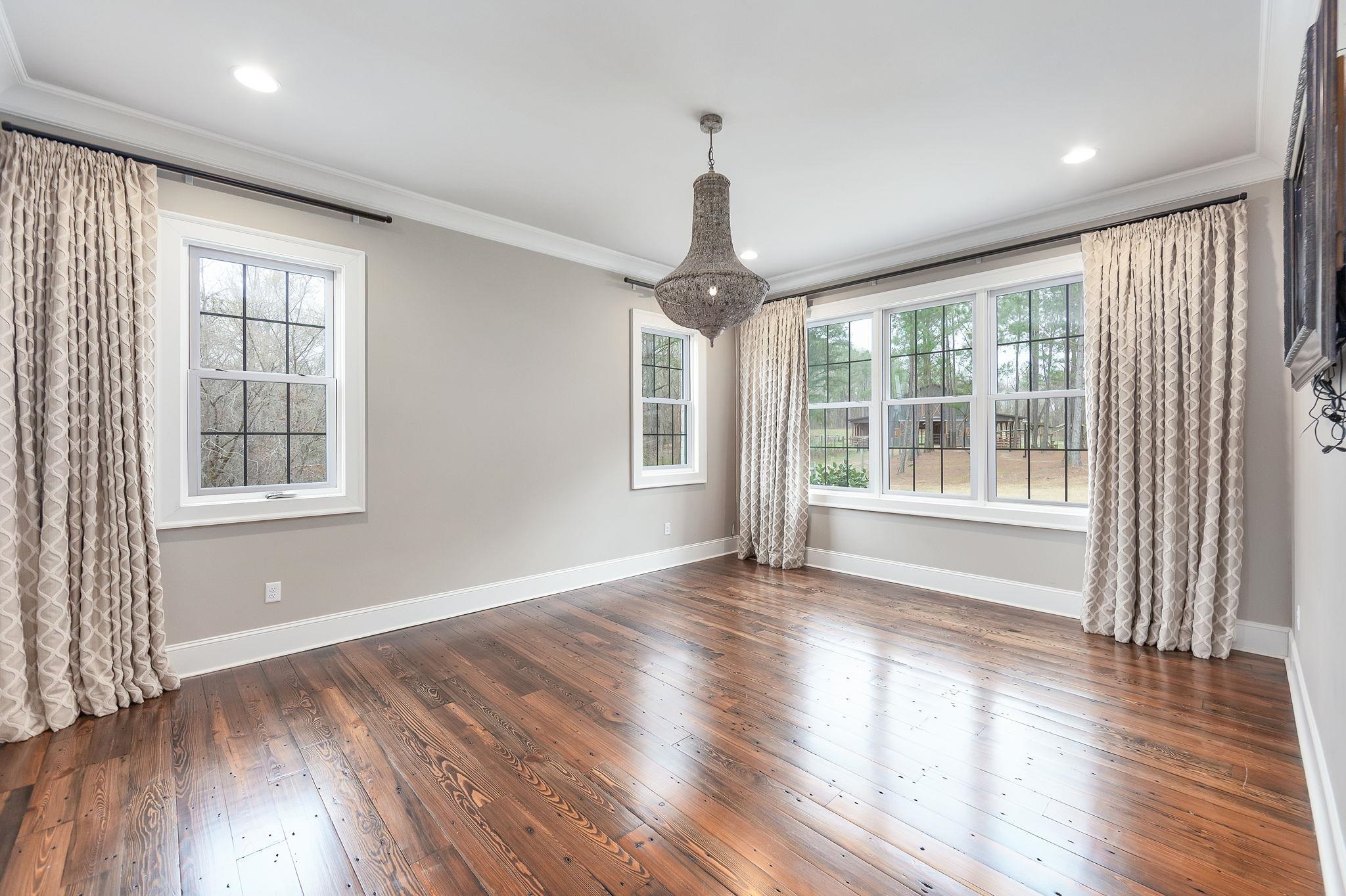 348 Countryside Drive Lexington, TN 38351 - Photo 17 of 39 a view of an empty room with wooden floor and a window