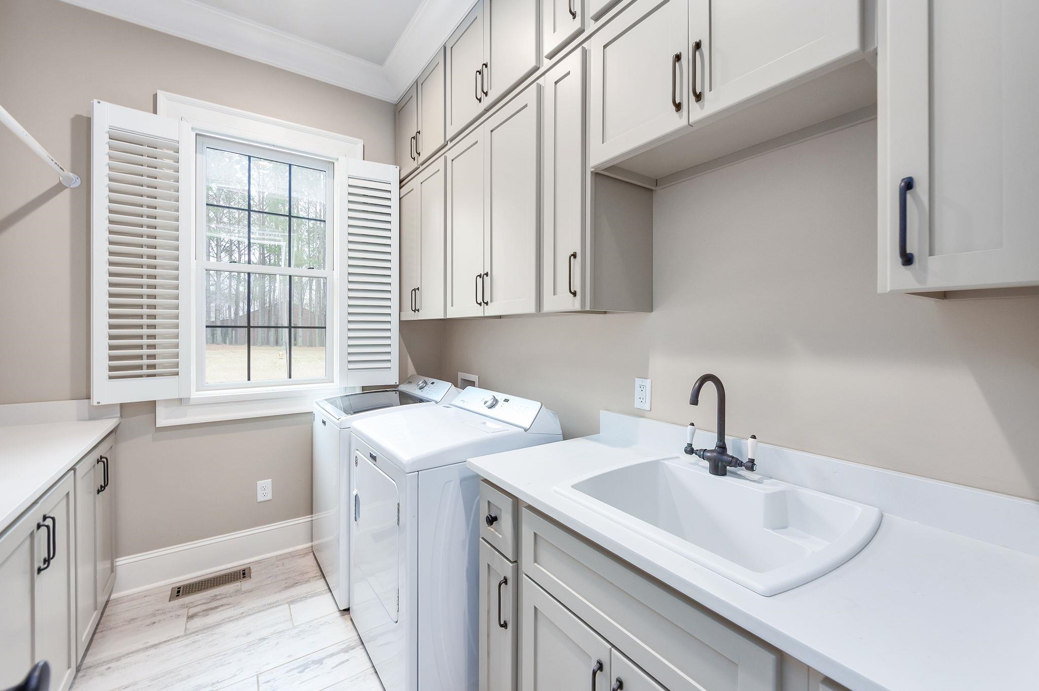 348 Countryside Drive Lexington, TN 38351 - Photo 24 of 39 a kitchen with a sink cabinets appliances and a window
