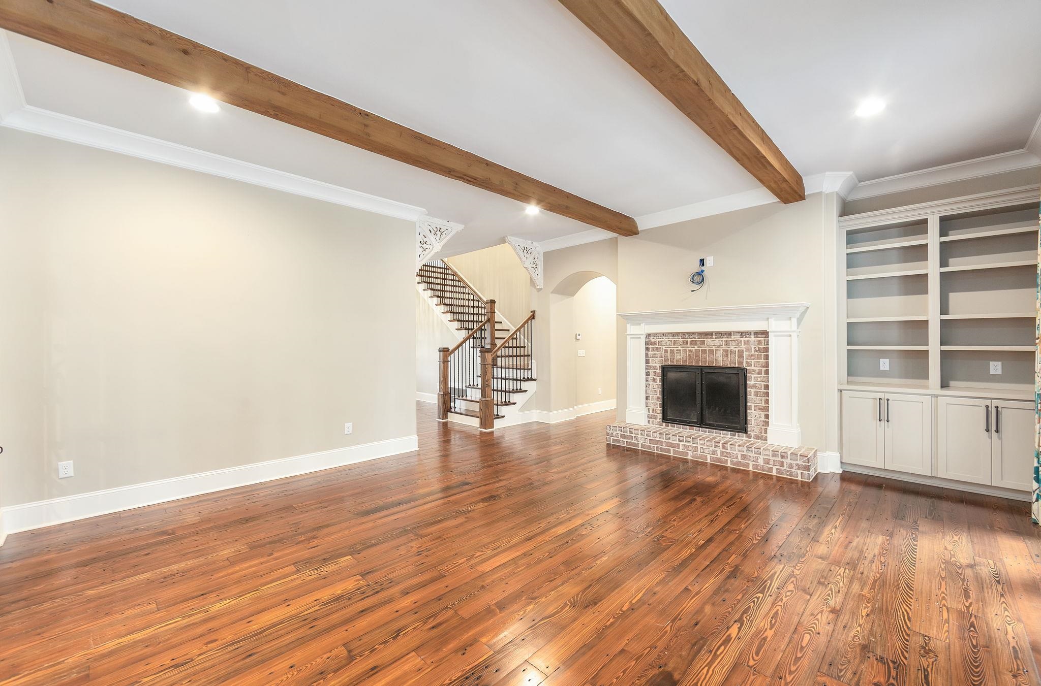 348 Countryside Drive Lexington, TN 38351 - Photo 8 of 39 a view of empty room with wooden floor and fireplace