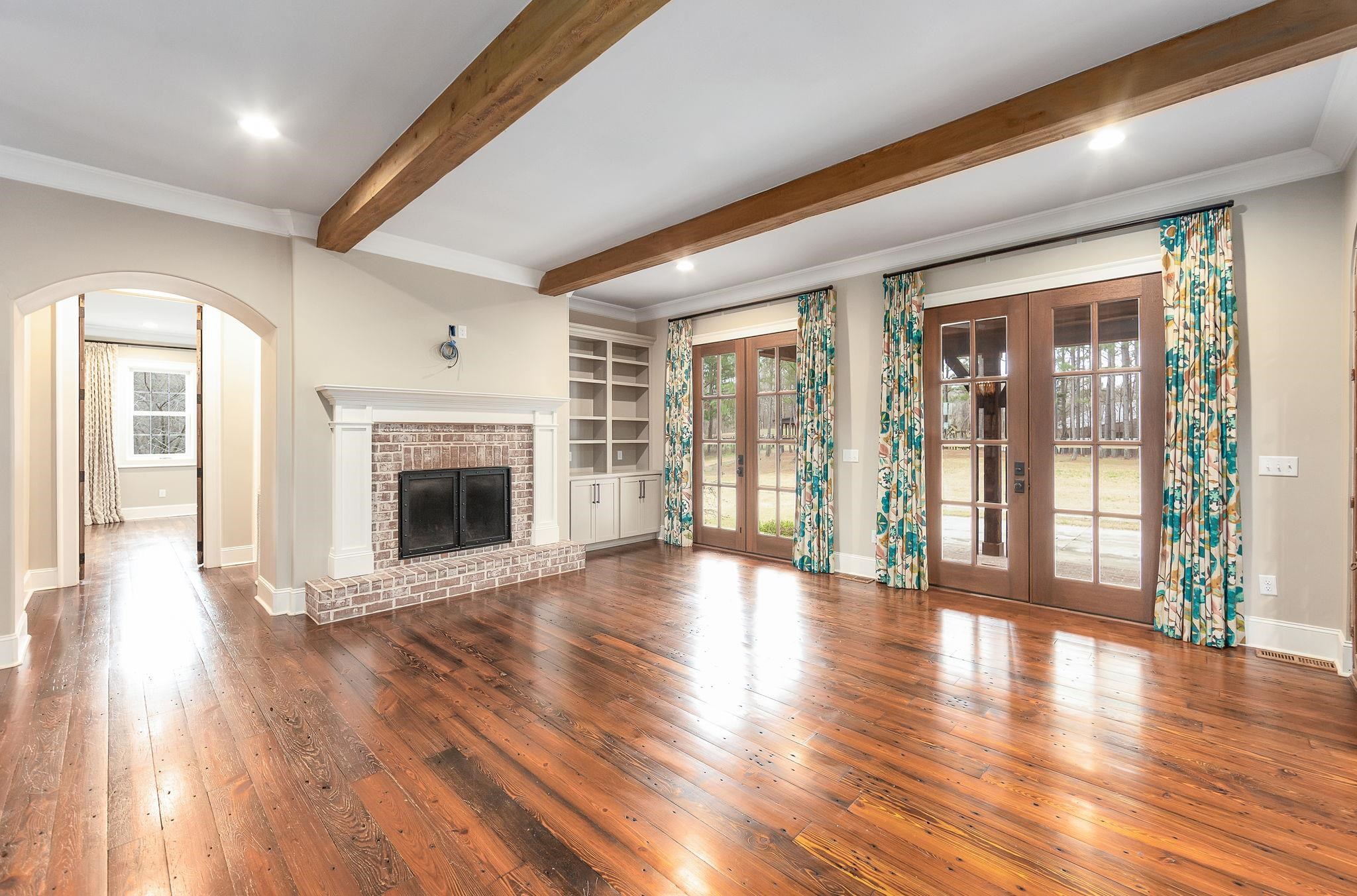 348 Countryside Drive Lexington, TN 38351 - Photo 9 of 39 a view of an empty room with wooden floor and a fireplace