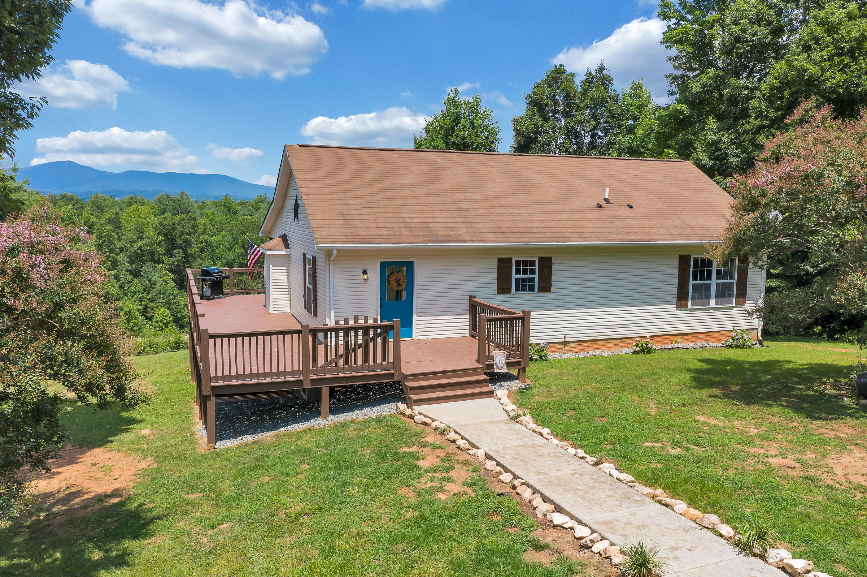 1145 Madcap Road Rocky Mount, VA 24151 - Photo 2 of 38 a front view of a house with garden