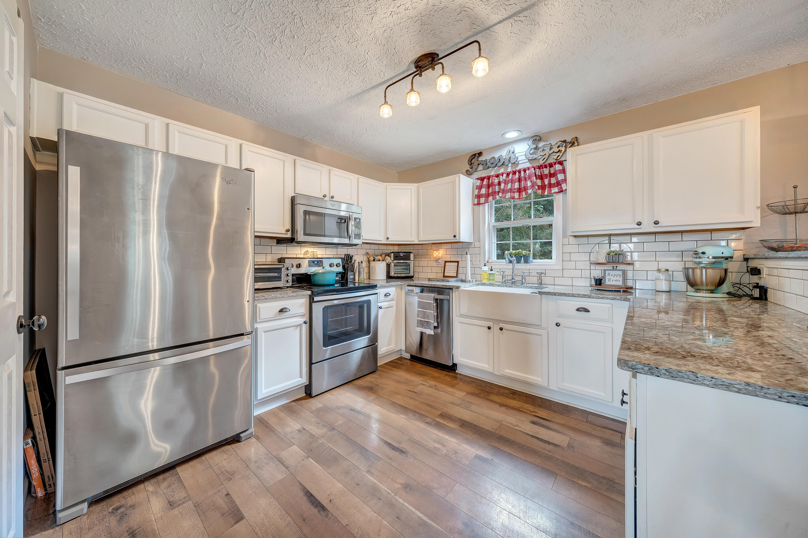 1145 Madcap Road Rocky Mount, VA 24151 - Photo 19 of 38 a kitchen with a refrigerator cabinets and wooden floor