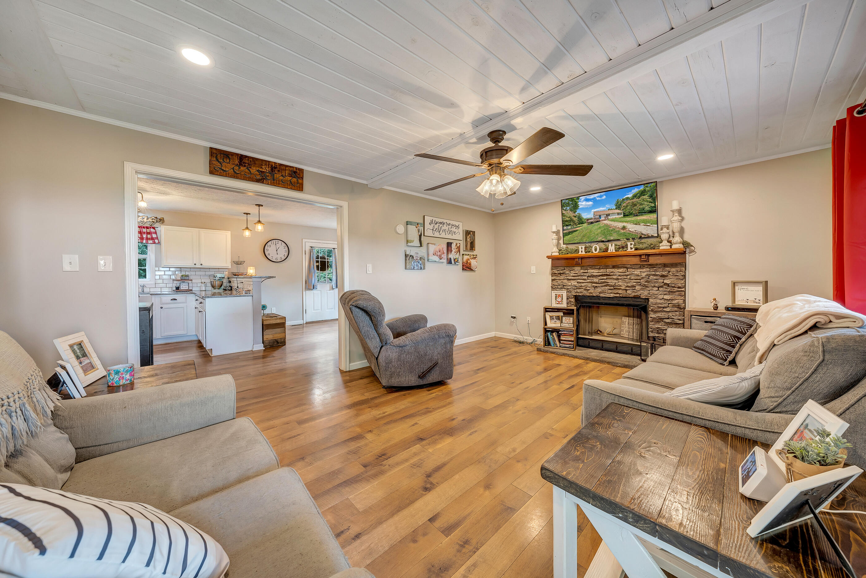 1145 Madcap Road Rocky Mount, VA 24151 - Photo 20 of 38 a living room with furniture a fireplace and a flat screen tv