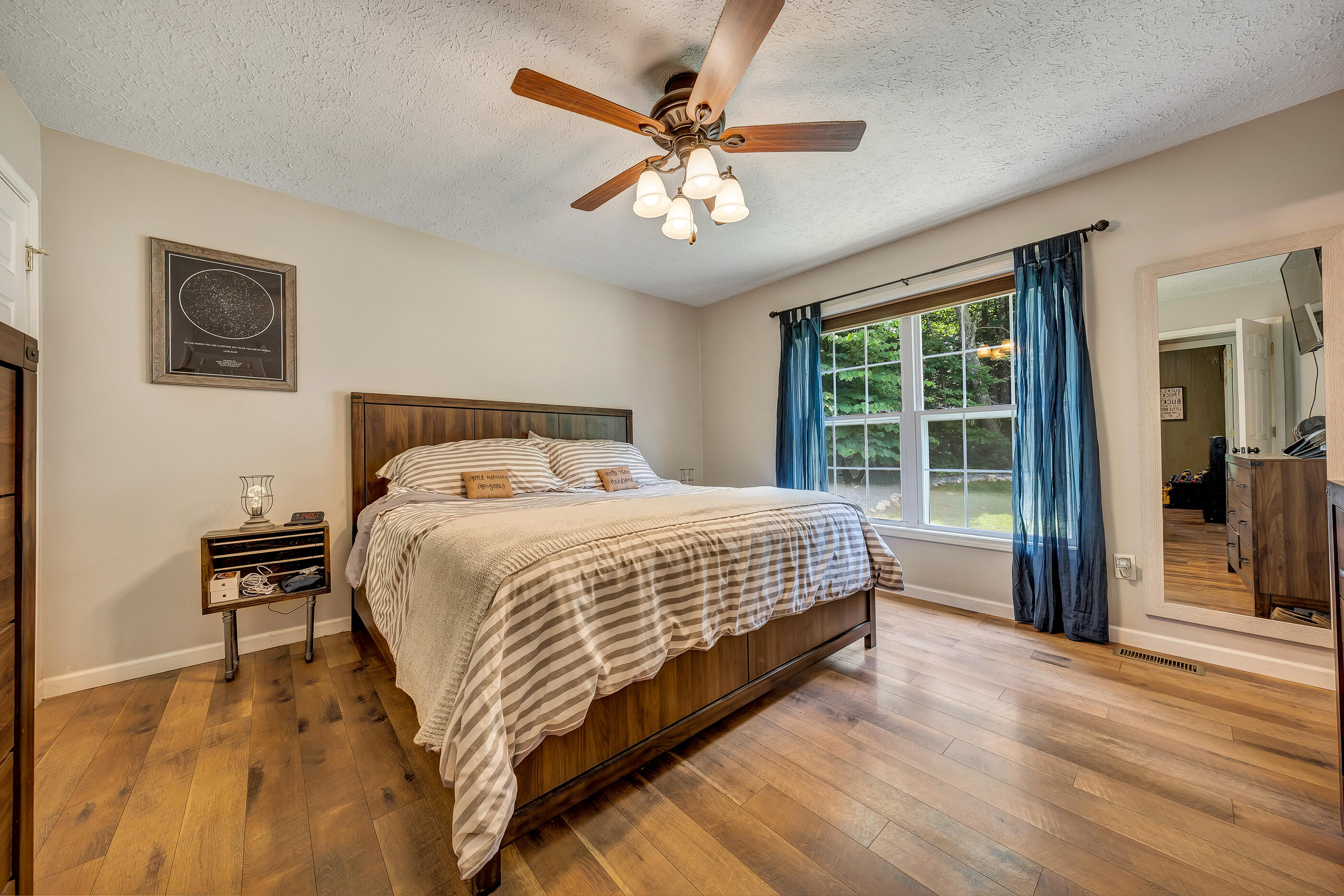1145 Madcap Road Rocky Mount, VA 24151 - Photo 23 of 38 a bedroom with a large bed and a chandelier