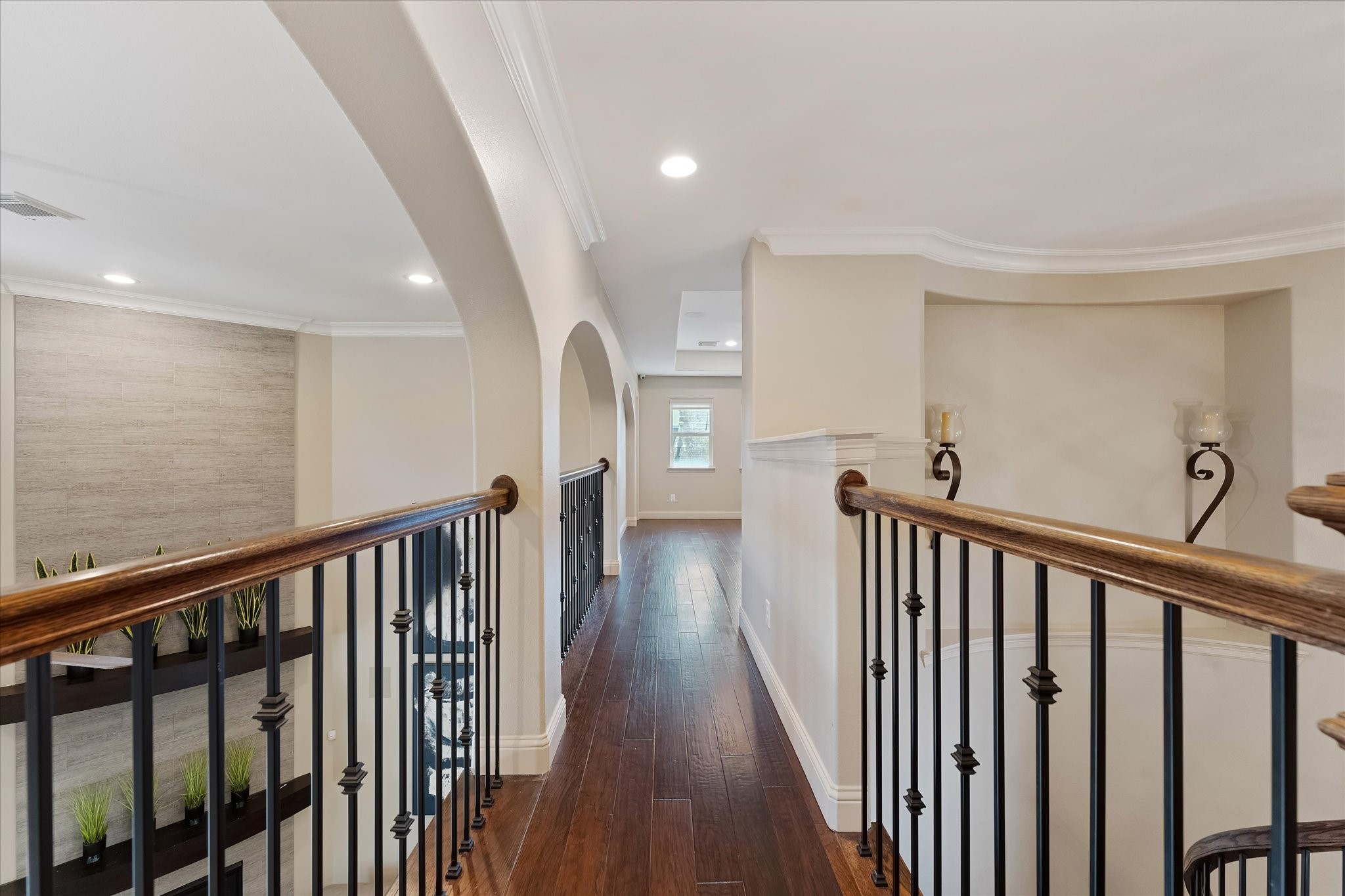 19 Paloma Bend Place Spring, TX 77389 - Photo 40 of 50 the curved wooden staircase in the foyer leads to the upstairs that includes two ensuite bedrooms, a large flex room with half bath, & a media room with dry bar.