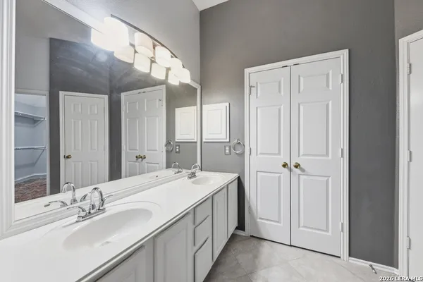 a spacious bathroom with a double vanity sink and a mirror