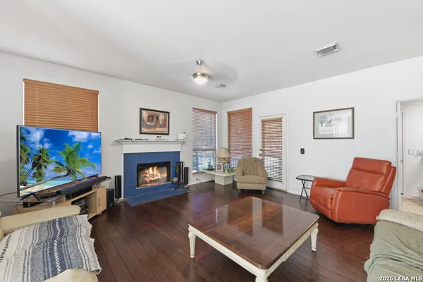 a living room with fireplace furniture and a flat screen tv