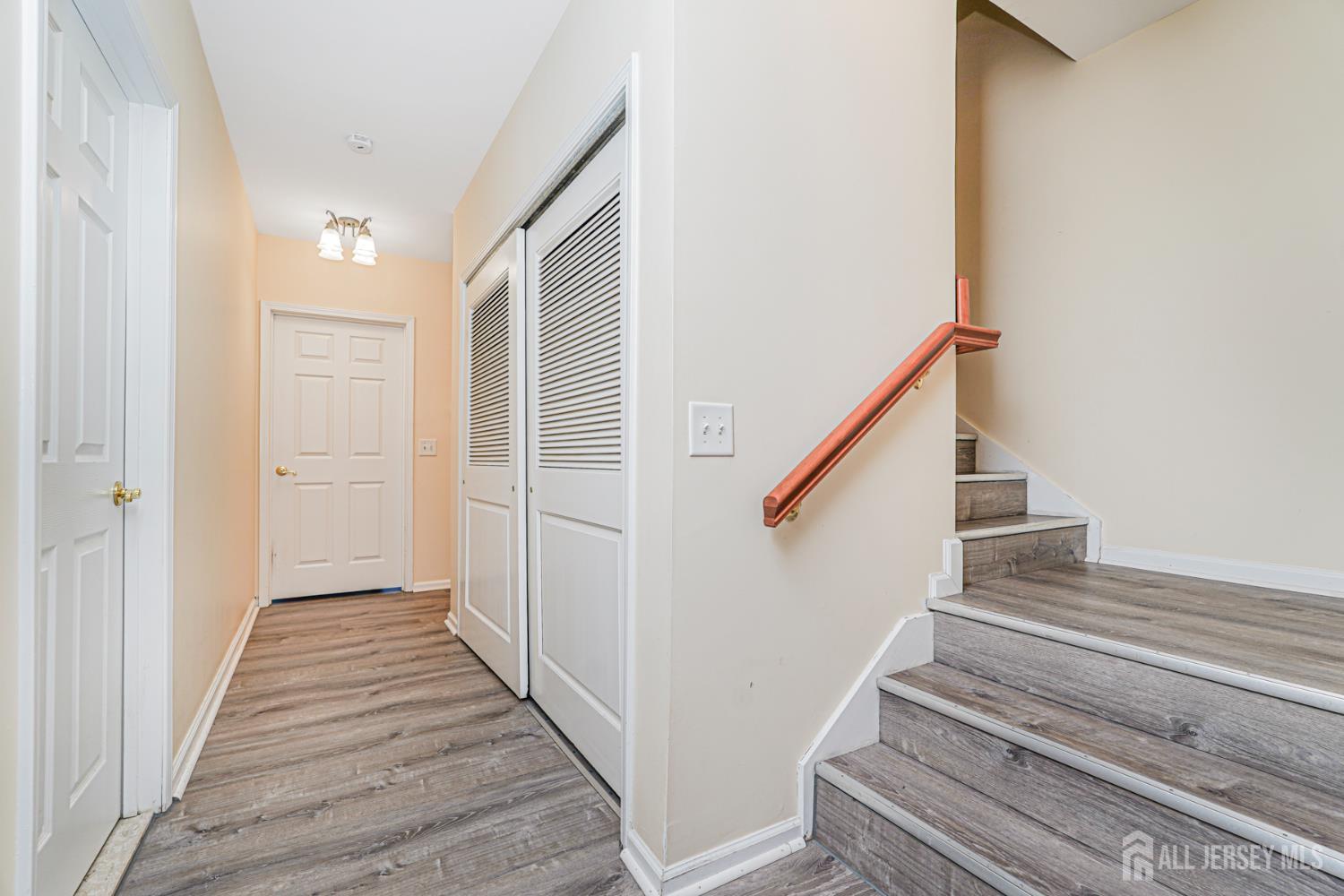358 Rector Street, Unit 308 Perth Amboy, NJ 08861 - Photo 11 of 29 a view of a hallway with wooden floor and staircase