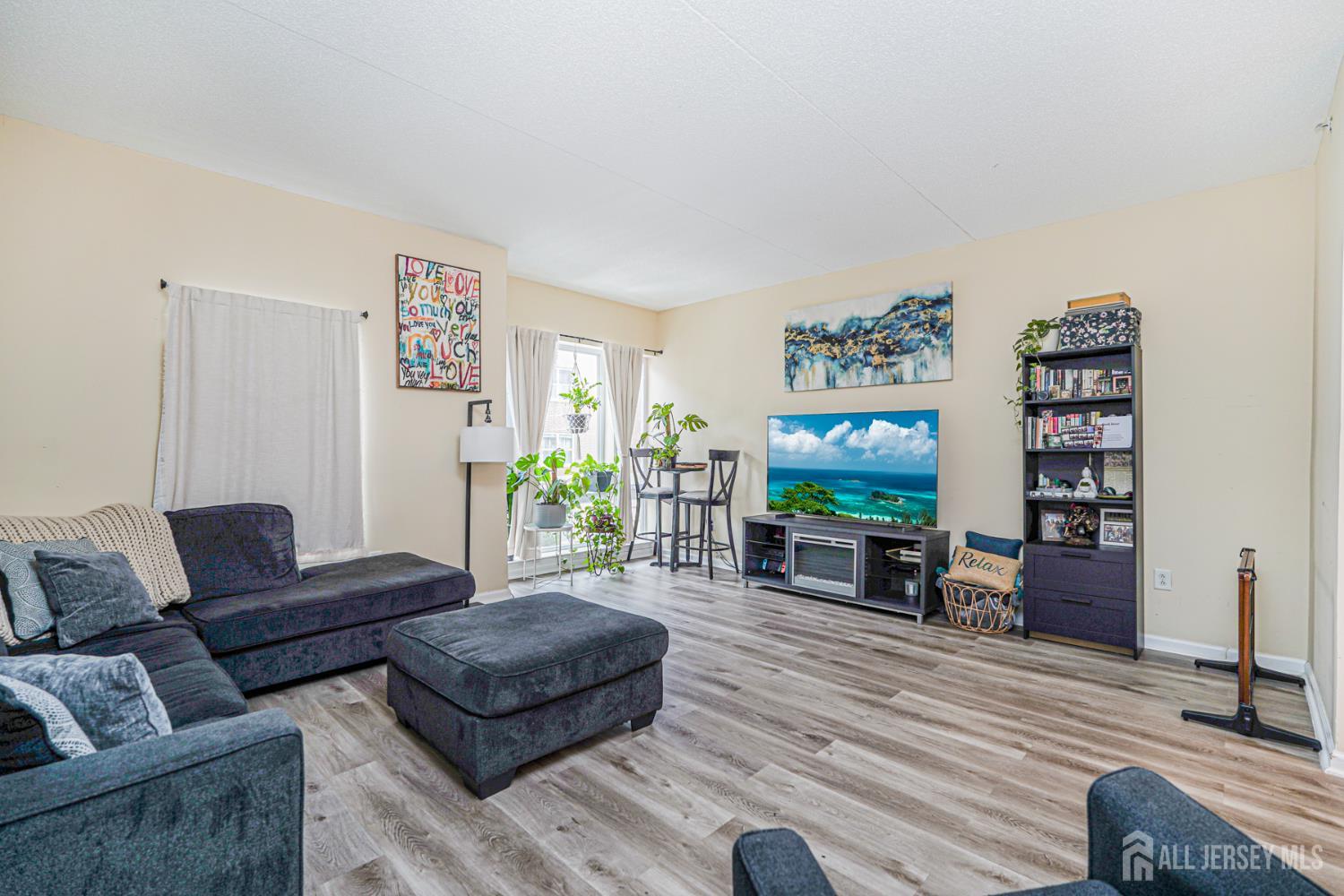 358 Rector Street, Unit 308 Perth Amboy, NJ 08861 - Photo 13 of 29 a living room with furniture and a flat screen tv