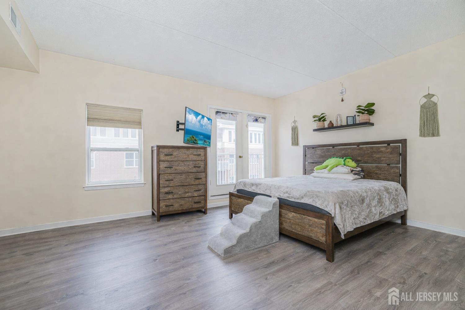 358 Rector Street, Unit 308 Perth Amboy, NJ 08861 - Photo 17 of 29 a spacious bedroom with a bed and a window