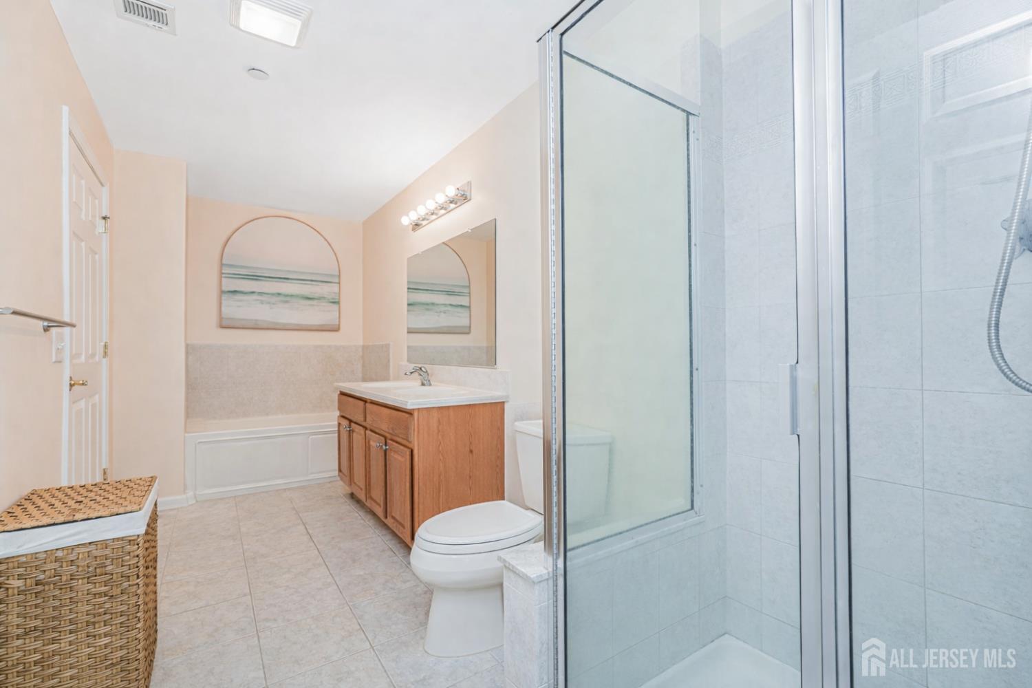 358 Rector Street, Unit 308 Perth Amboy, NJ 08861 - Photo 18 of 29 a bathroom with a granite countertop toilet a sink and a mirror