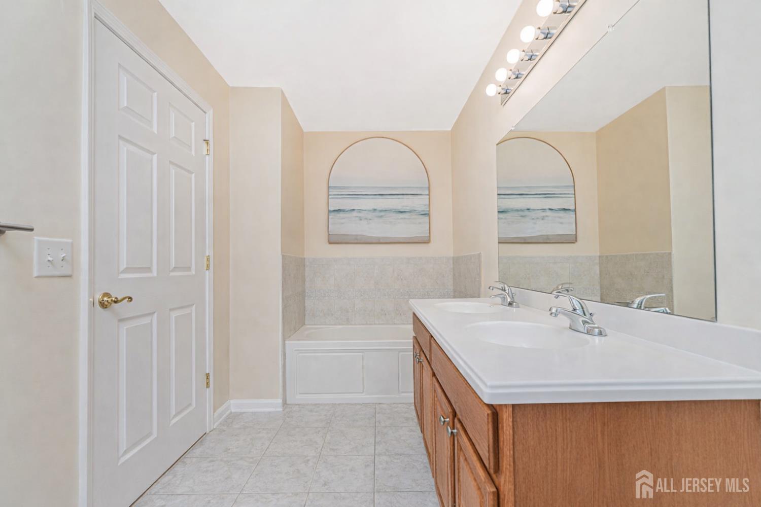 358 Rector Street, Unit 308 Perth Amboy, NJ 08861 - Photo 19 of 29 a bathroom with a sink a vanity and a mirror