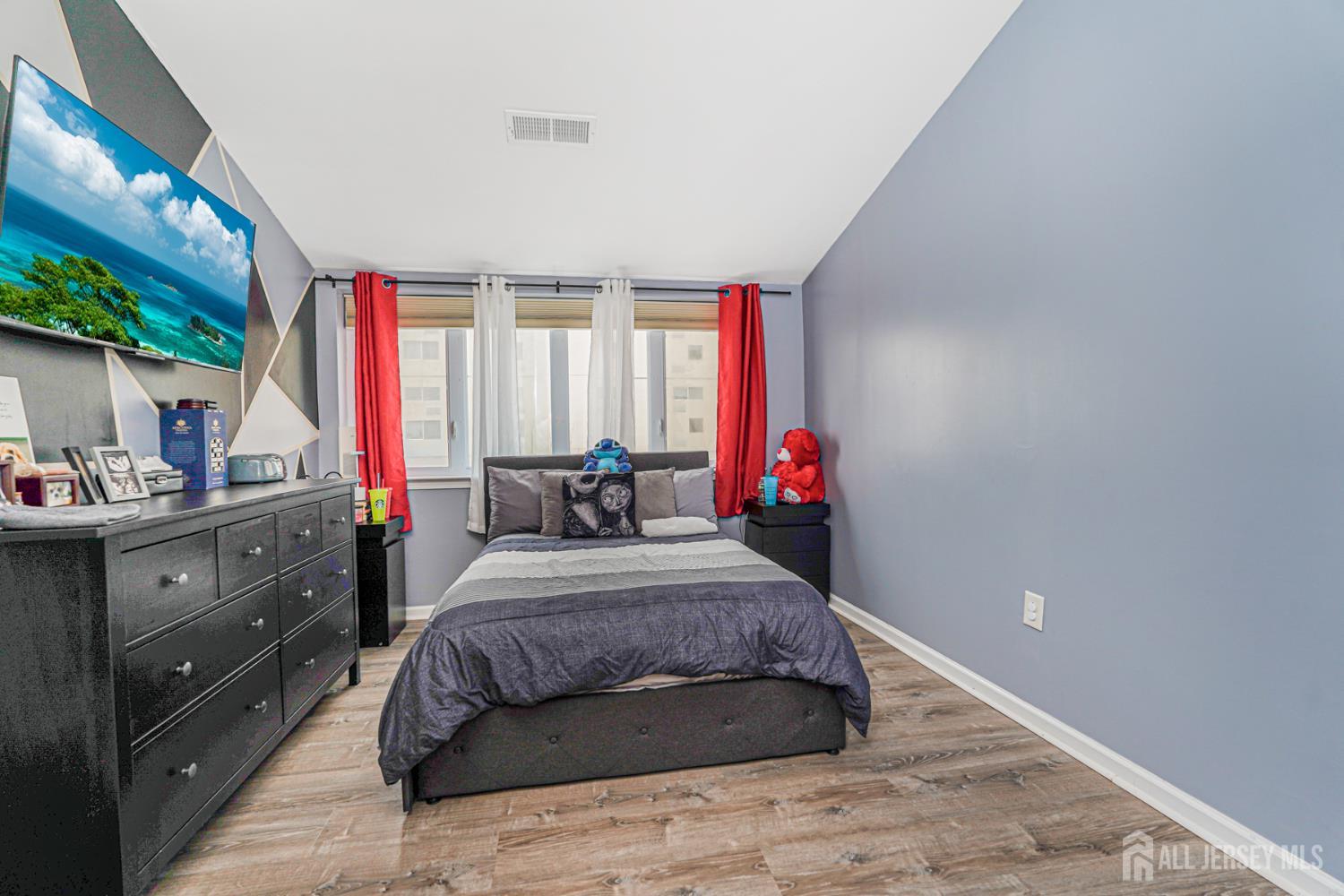 358 Rector Street, Unit 308 Perth Amboy, NJ 08861 - Photo 25 of 29 a bedroom with a bed and a dresser