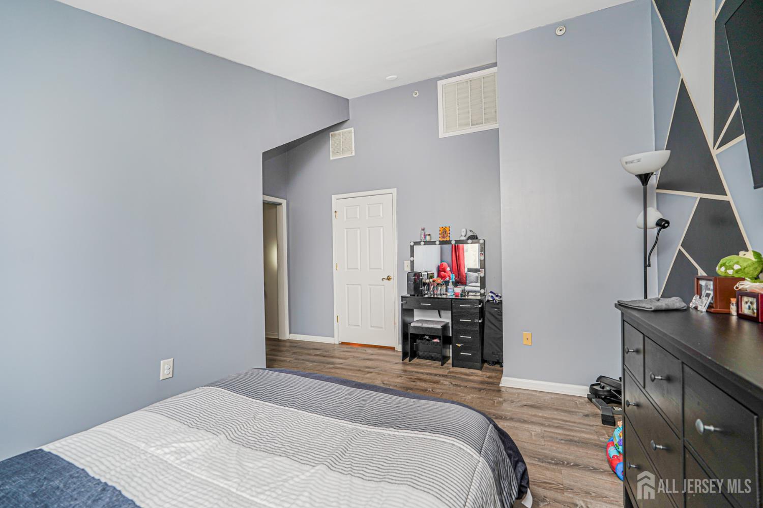 358 Rector Street, Unit 308 Perth Amboy, NJ 08861 - Photo 26 of 29 a bedroom with a bed and a flat tv screen on dresser