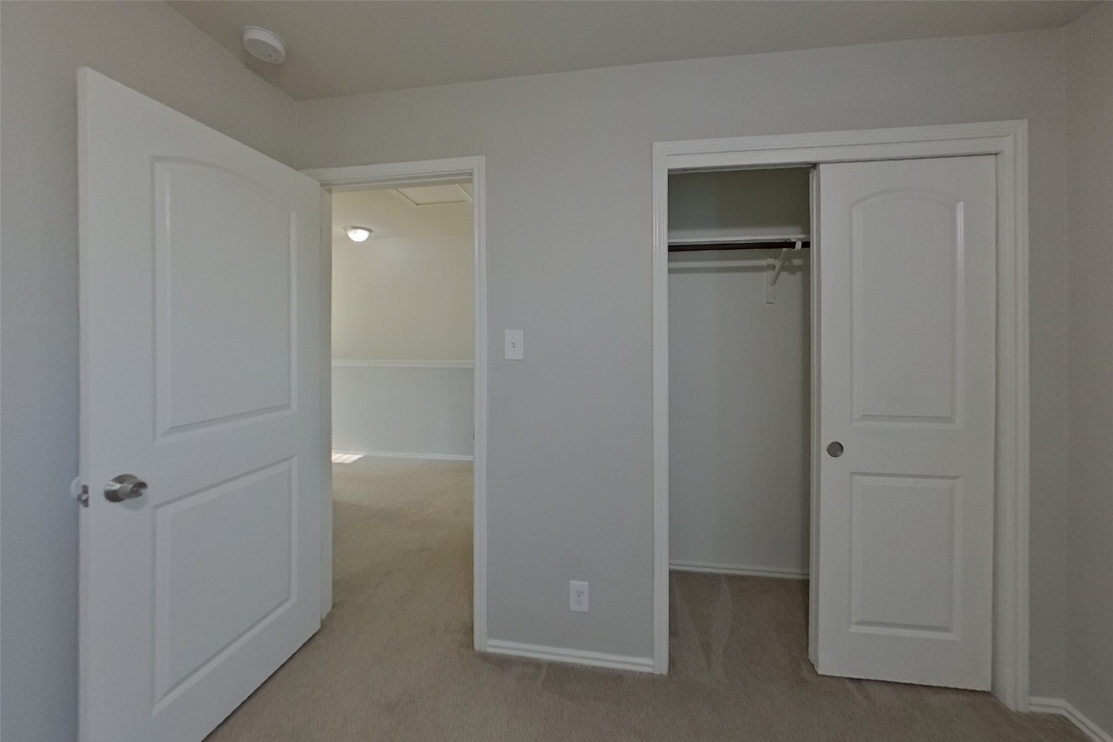 240 Dragon Ridge Road Buda, TX 78610 - Photo 12 of 20 Plush carpeting and classic panel doors define this clean bedroom entry and closet space.
