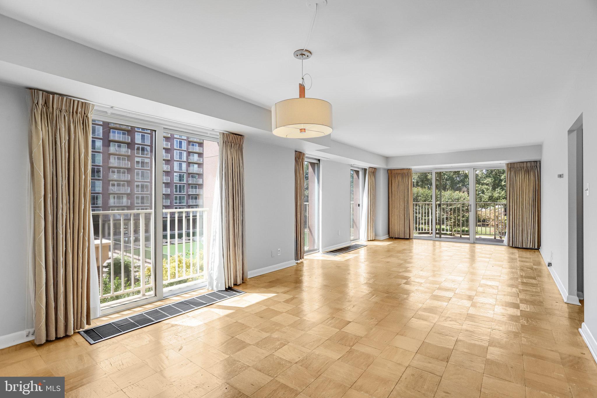 510 N Street Southwest, Unit N217 Washington, DC 20024 - Photo 6 of 19 a view of an empty room with wooden floor and a window