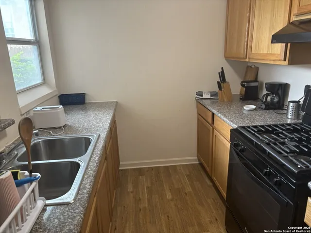 a kitchen that has a sink and a stove