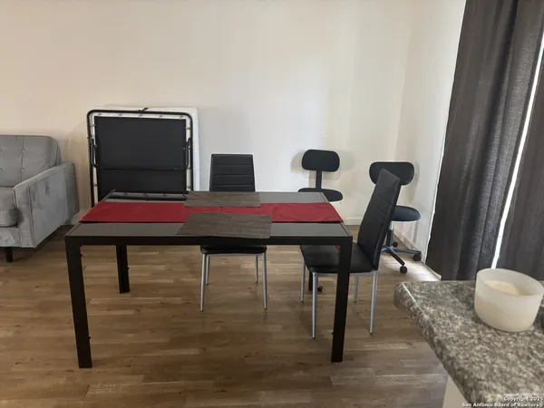 a dining room with furniture and wooden floor