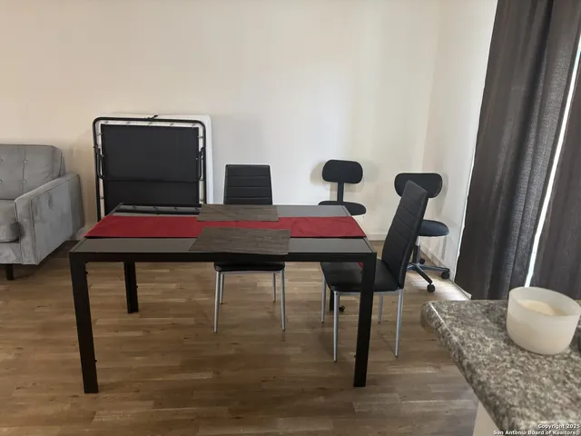 a dining room with furniture and wooden floor