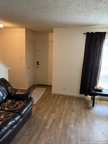 a view of a room with wooden floor