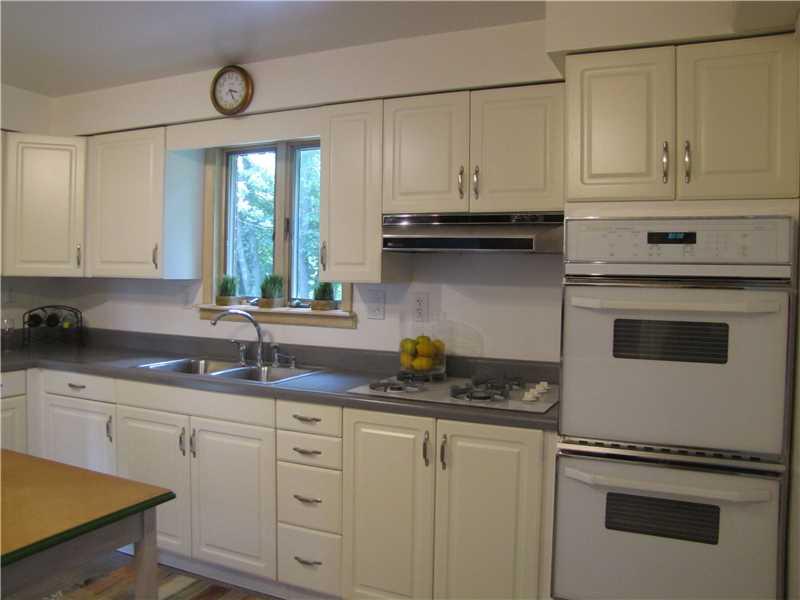 2810 Ipnar Road North Huntingdon, PA 15642 - Photo 5 of 25 Kitchen. This modern kitchen is light and airy. White cabinetry and gray floors, gas cook top and electric double wall ovens make cooking here a pleasure. Double stainless steel sink bowls, and updated faucet. The window overlooks the private , wooded backyard.