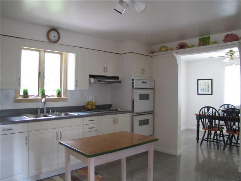 2810 Ipnar Road North Huntingdon, PA 15642 - Photo 6 of 25 Kitchen. The kitchen showing the dining Room to the right. A table adds extra counter space and character, plenty of space to add an island with counter seating. Updated lighting.