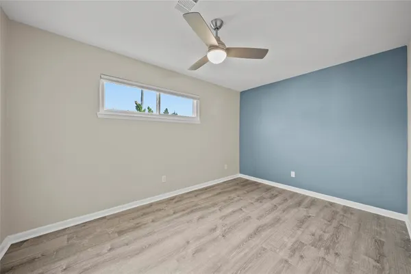 a view of empty room with wooden floor