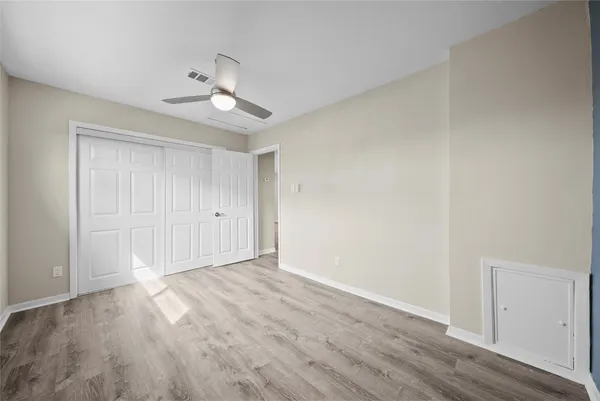 a view of an empty room and wooden floor