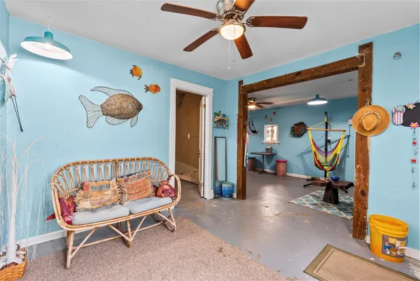 a bedroom with furniture and a chandelier fan