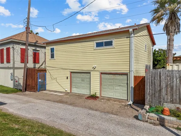 a view of a house with a yard and garage