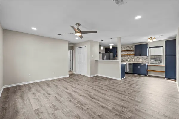 a view of a kitchen with a sink and a refrigerator