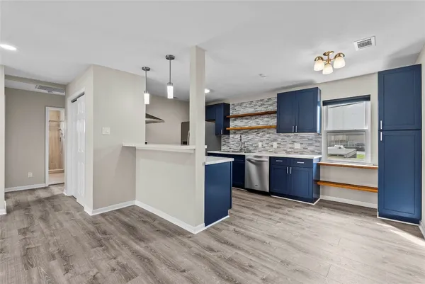 a kitchen with a refrigerator sink and cabinets