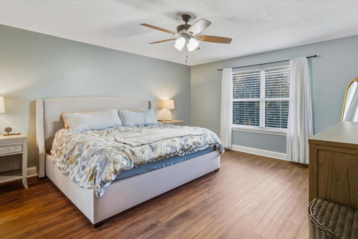 486 Jillian Drive Crestview, FL 32536 - Photo 13 of 44 a bedroom with a large bed chandelier and a window