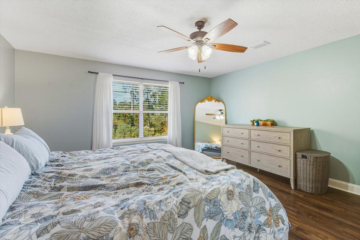 486 Jillian Drive Crestview, FL 32536 - Photo 16 of 44 a bedroom with a bed and a chandelier